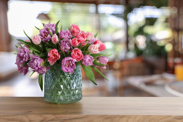 Fototapeta premium Bouquet of beautiful tulips on table in restaurant