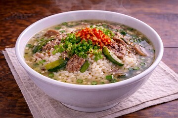 Korean soup bowl with meat and spicy garnish