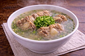 Meatball soup bowl with herbs closeup