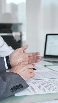Business people engaging in a meeting, discussing important contract terms and financial agreements, clarifying legal details, signing documentation, and collaborating on corporate projects