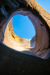 Natural rock formation with potholes carved by erosion under clear blue sky creating stunning view of nature art Lei Dan Stone Field Thailand