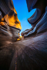 Narrow canyon rock formation blue sky sunlight potholes natural erosion sandstone landscape Lei Dan Stone Field Thailand