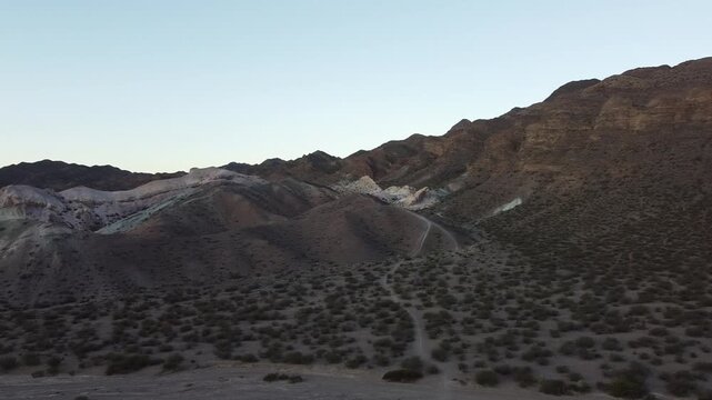 Desert Mountain Valley Landscape with RVs and Colorful Rock Formation