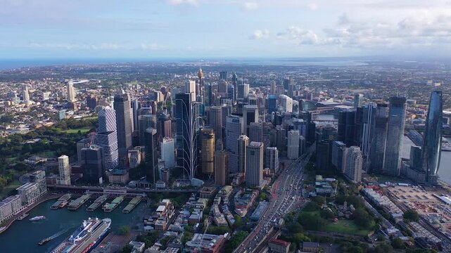 Aerial drone view of Sydney central business district with dense skyline of modern skyscrapers, busy roads, harbor waterfront and expansive urban landscape of Sydney, Australia