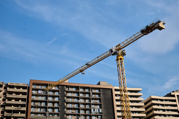 Yellow Tower Crane at Modern Apartment Construction Site