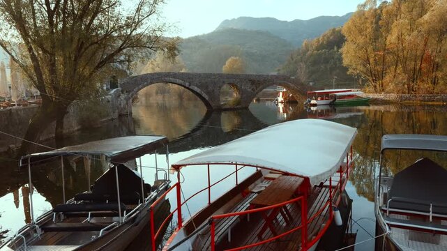 Rijeka Crnojevica bridge with boats in Montenegro