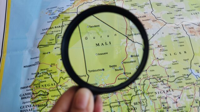View of Mali, on a geographic map of Africa, seen using a magnifying glass