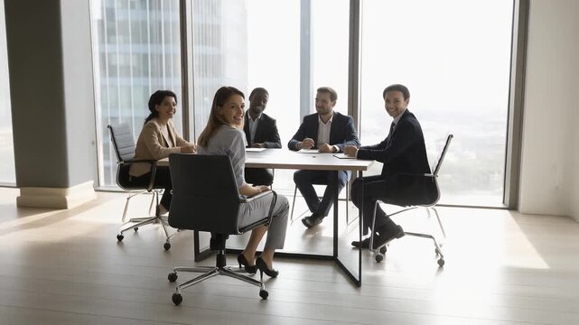 multicultural business team talking together at round table during daytime meeting
