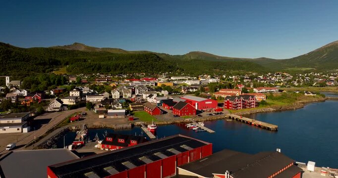Red houses on waterfront Melbu town, Lofoten Islands. Sunny day in Noway. Drone panoramic