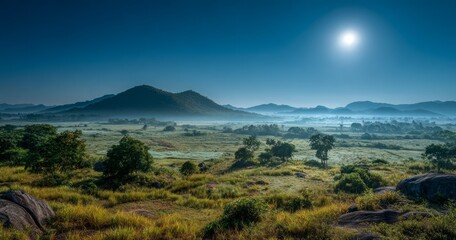 Obraz premium Serene Landscape Under Bright Moonlight with Misty Mountains and Lush Greenery