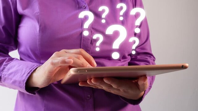 Close-up of a businesswoman interacting with her tablet, displaying an animation of several question marks.