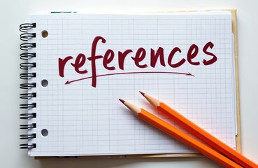 Obraz premium Notebook with references written in red pen. Two orange pencils lie on the page. Simple concept for business, education, or research material.