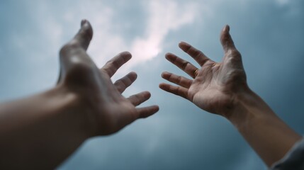 Reaching out: Open hands towards cloudy sky for hope concept