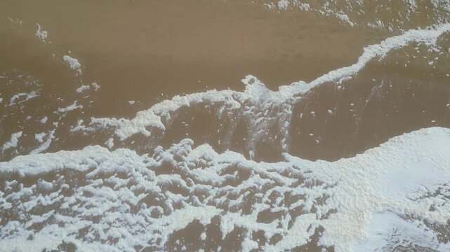 View from above the ocean foam and the wite sea at Guincho beach, after Storm Kristin. Cascais,Portugal.