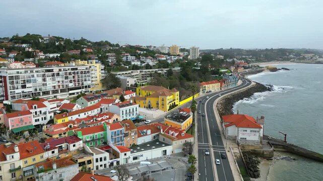 Aerial view at a cloudy day from the marginal and the Pa&ccedil;o de Arcos village. Backwards drone shot. Oeiras,portugal