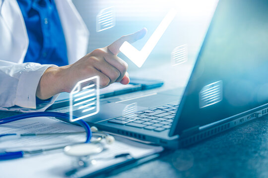 Doctor Approving Medical Documentation on Laptop with Digital Healthcare Workflow and Clinical Decision Concept