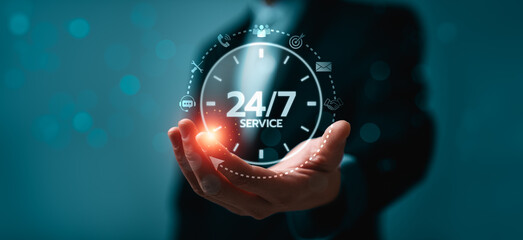 Business hand presenting glowing 24/7 service clock interface with support icons, symbolizing continuous customer assistance, communication, and availability for professional service operations © Sutthiphong