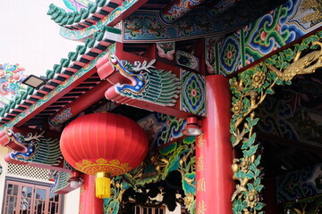 Traditional Chinese temple architecture with vibrant dragon carvings and red lanterns