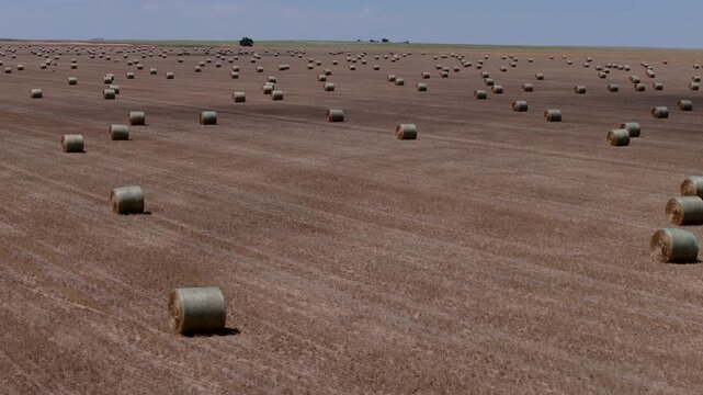 Aerial pullback reveal of expansive agricultural field stretching across the breadbasket of America