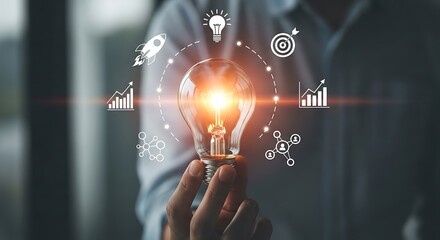Person holding a glowing lightbulb with futuristic icons and graphics