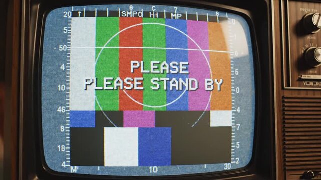 Retro TV showing 'Please Stand By' test pattern with static