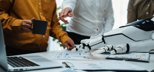 Fototapeta premium Professionals engage in a dynamic meeting with advanced robotic technology, exploring innovative ideas and enhancing collaboration in a modern office setting.Noogenesis