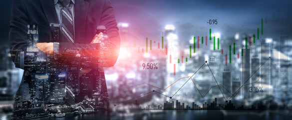 A professional businessman stands confidently in front of a modern city skyline illuminated at night, showcasing stock market charts reflecting investment trends and financial growth. Scalp © InfiniteFlow