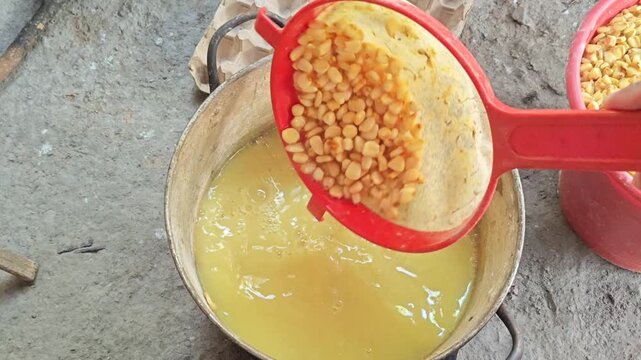 Transferring nixtamalized corn into a plastic bucket