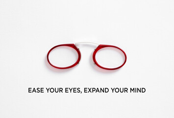 Red pince nez reading glasses on white background