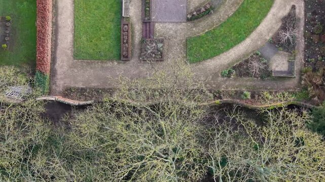 Top-down left pan of Crinkle Crankle wall with trees and gardens