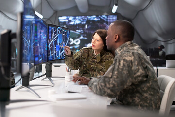 Soldiers In Military Control Center Monitor Maps On Multiple Screens