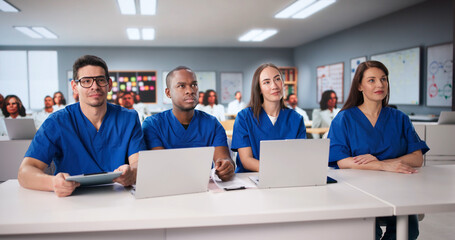 Medical Students In Lecture Hall Using Laptops