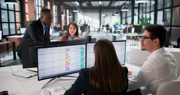 Diverse Business Team Analyzing Data On Computer Screen