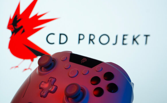 Dhaka, Bangladesh- 20 Mar 2025: A close-up of a gamepad with the CD Projekt seen on screen in the background.