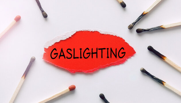 gaslighting concept with burned matches and torn red paper, psychological abuse and manipulation symbol
