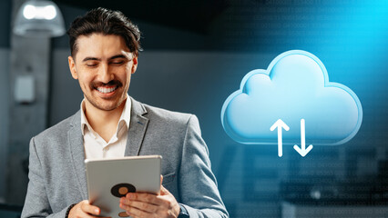 Man using tablet to manage data storage in cloud computing environment at modern office