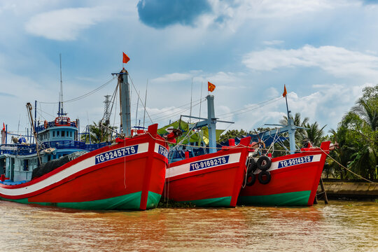 Traditional wooden boat cruising on the Mekong River in My Tho, Vietnam