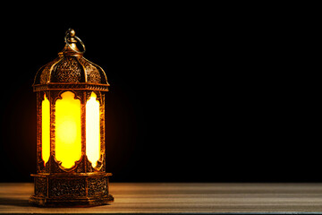 Golden Arabic Lantern with Warm Glow on Wooden Table Against Black Background. Ramadan and Eid Mubarak Concept. High quality photo © 7TridentSea