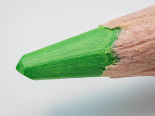 Macro view of a sharpened green crayon.