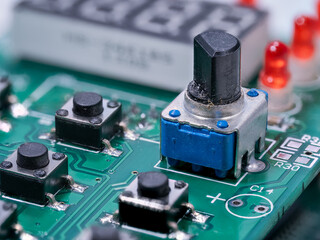 Rotary potentiometer with microswitches on a printed circuit board.