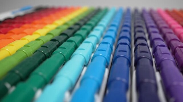 Rainbow array of colorful crayons arranged in a visually appealing gradient, close-up shot