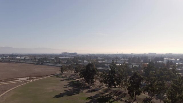 Cinematic drone shot of Highway 101 traffic flow through the South San Jose tech corridor. Ideal for business projects highlighting California infrastructure, transportation, and urban commuting.
