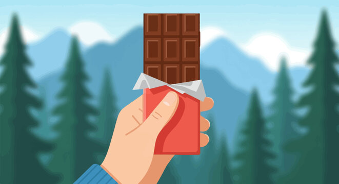 Hand holding a chocolate bar in a mountain forest landscape