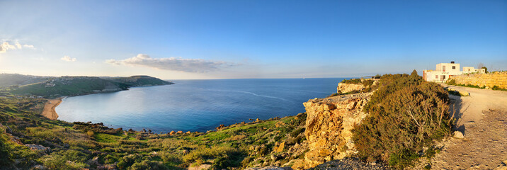 Coastal landscape near Tal-Mixta Cave with sea, cliffs and houses. Mediterranean impressions on a sunny day in winter