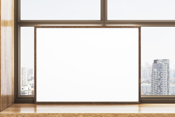 Blank wooden frame poster mockup on windowsill with modern city view through large glass window in bright daylight. 3D Rendering