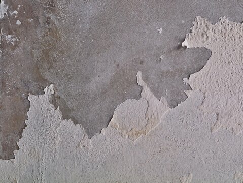 Peeling white paint texture on old concrete wall. Ideal for vintage backgrounds or urban grunge design concepts