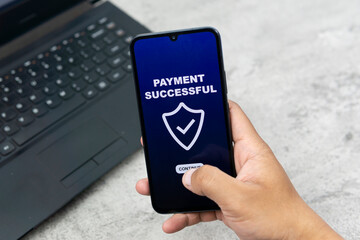 Payment by phone technology concept. Hand holding smartphone to pay for shopping, digital online transactions, sales,  and finances via mobile apps. A modern lifestyle with electronic cards and networ