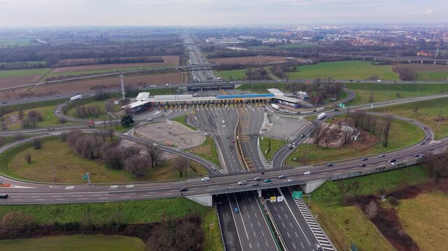 Highway toll plaza with cars passing through the tollgate aerial view