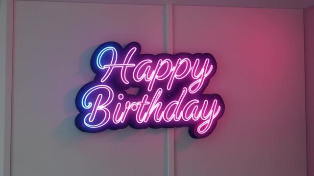 A neon Happy Birthday sign hangs on a wall with a pink glow in the background, casting a shadow for a celebration