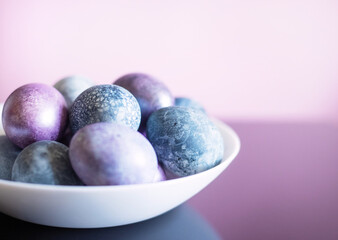painted Easter eggs on a light pink background
